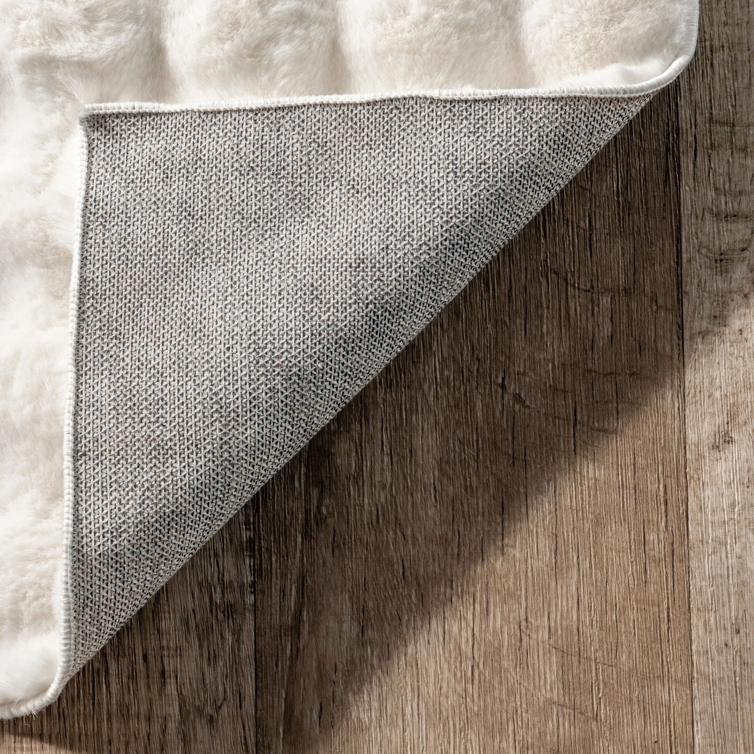 Jeni Solid Faux Rabbit Machine Washable Area Rug